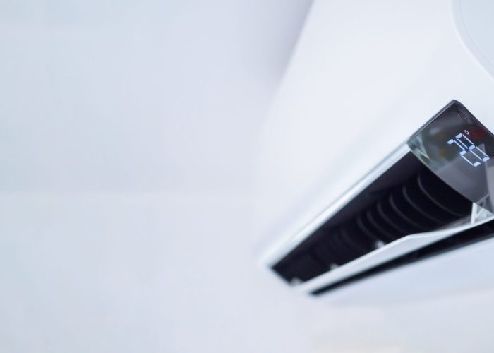 Air conditioner on white wall room interior background