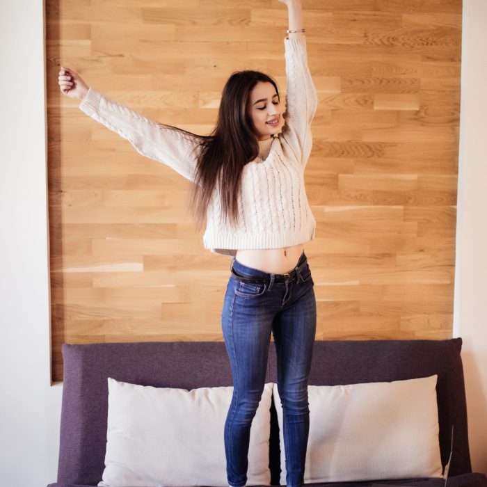 Young attractive woman work at home stretching arms to relax after working day